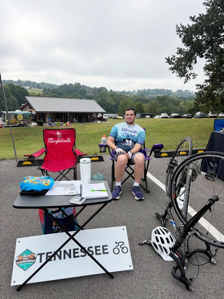 Adaptive cyclist beside a handcycle at the I CAN Special Needs Resource Fair at Trinity Grace Farm