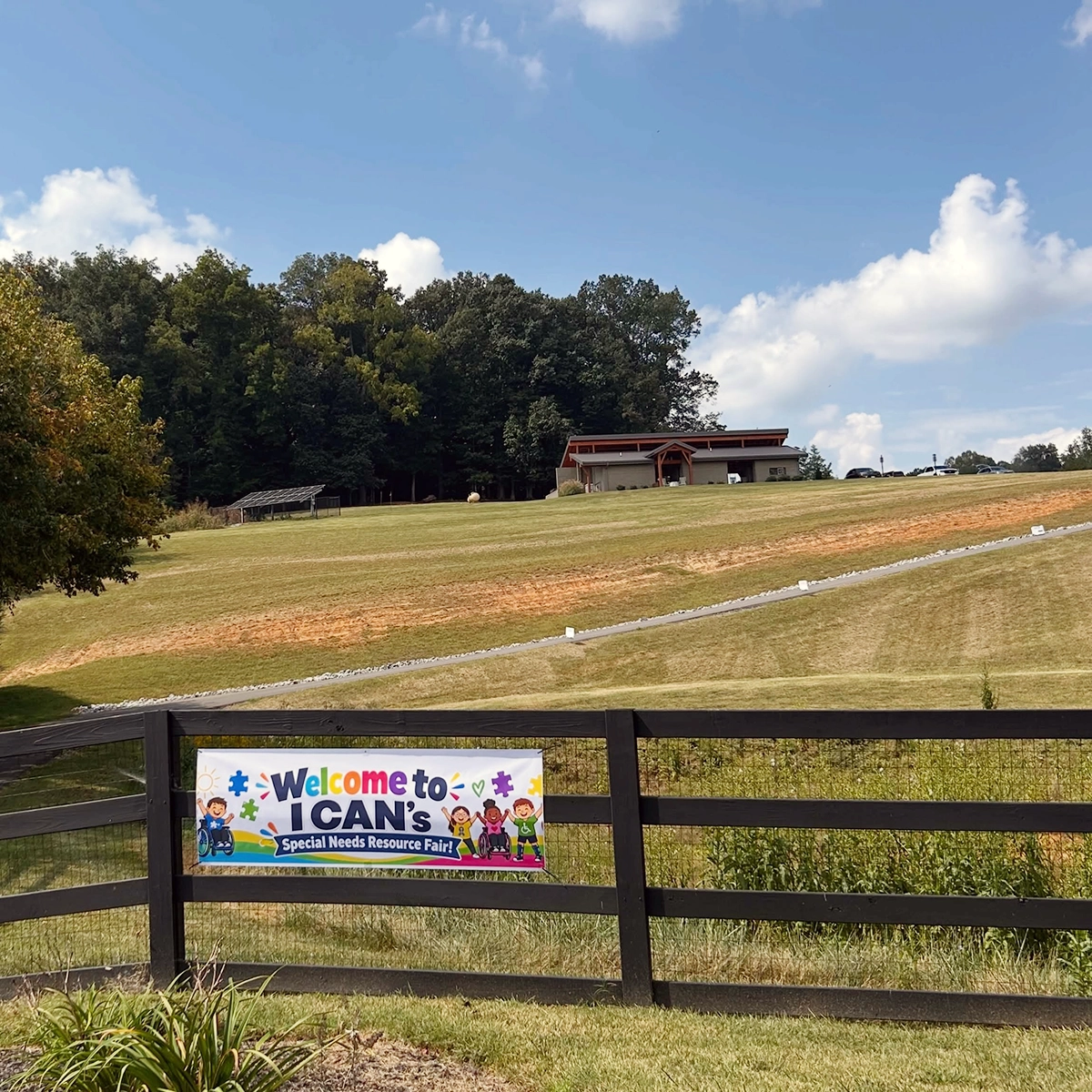 Welcome sign for the I CAN Special Needs Resource Fair overlooking Trinity Grace Farm